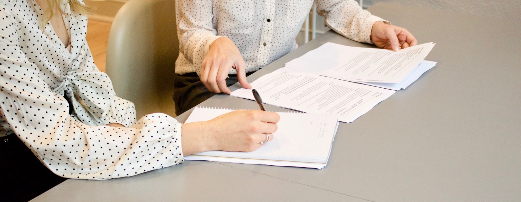 Two people reviewing financial documents together at a desk